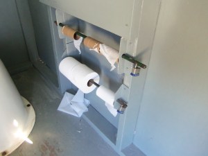 For some reason, the preferred method of securing toilet paper rolls in this part of the world is a padlock system. Apparently, pit house toilet paper theft runs rampant in the northwoods.