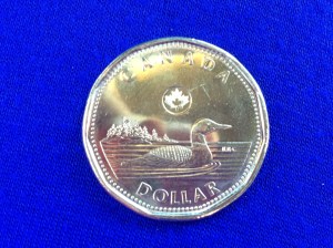 A Loonie! Note that this is apparently a new Loonie, in which a giant maple leaf is imprinted on the sun. Canada may be harboring nefarious plans involving claiming the sun for itself.