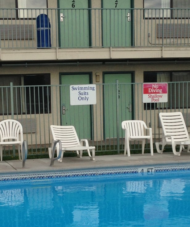 This sign says "Swimming Suits Only." I like to think they had an epidemic of people swimming in clothes, though I am thinking it's more likely there were a lot of people wearing their birthday suits in the pool.